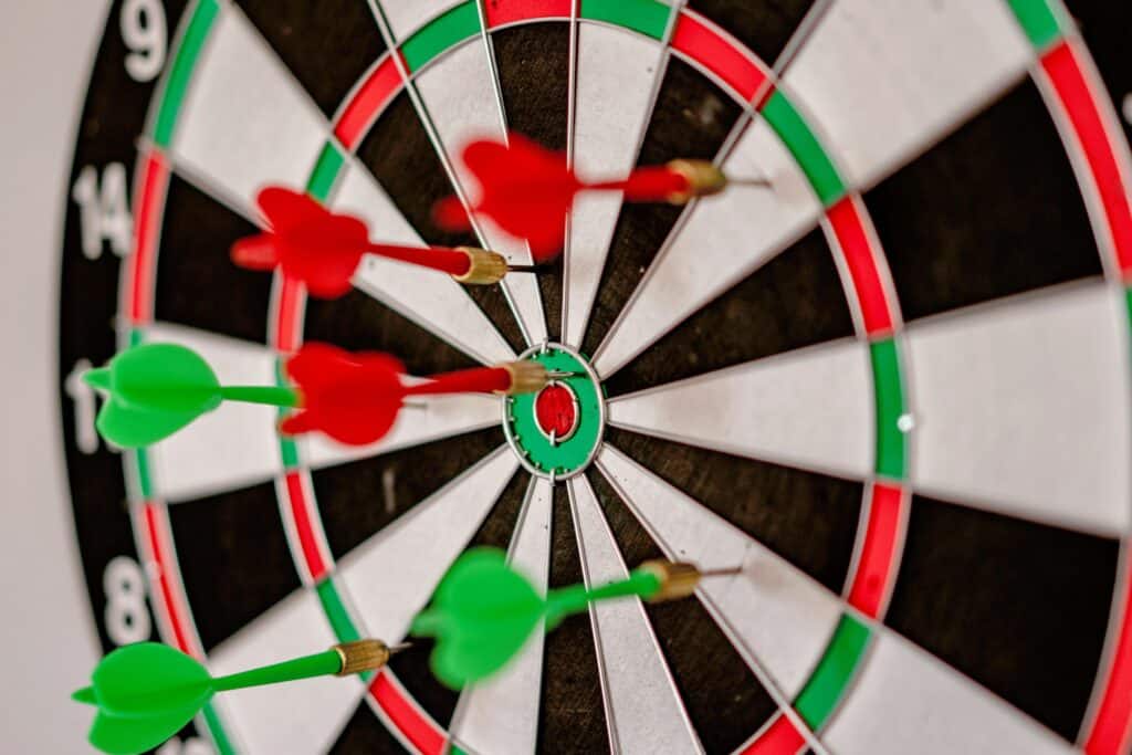 Blogs - Close-up of a dartboard with three darts embedded in the scoring areas